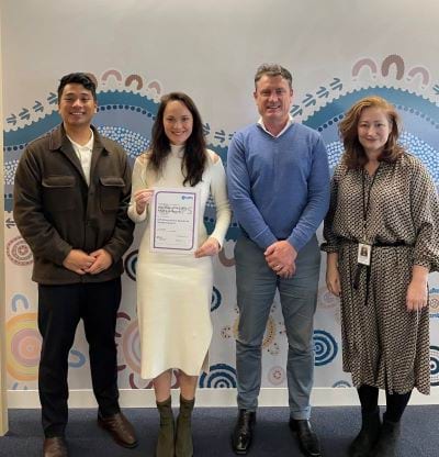 Photo of four employees from the Department of Jobs, Skills, Industry and Regions showing their certificate of CIPS accreditation